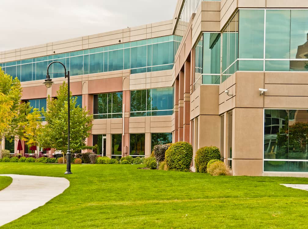 office building with windows and grass