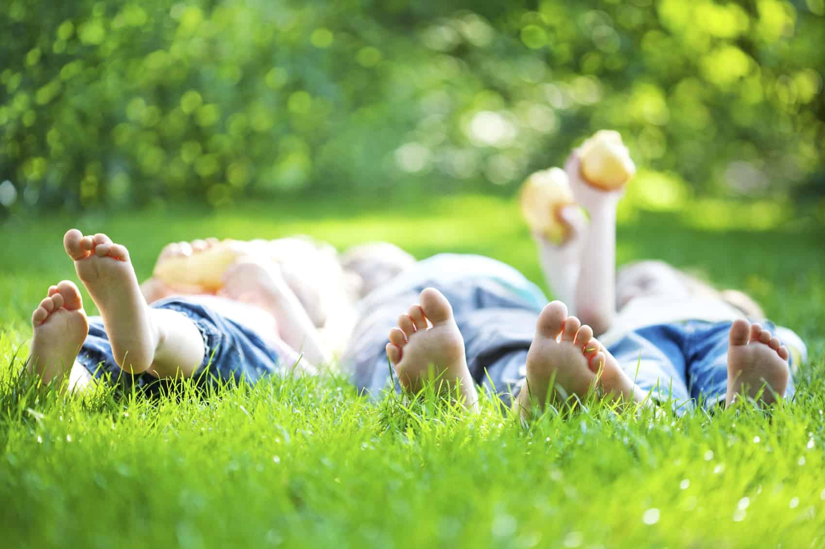 people laying down in grass enjoying pest free yard